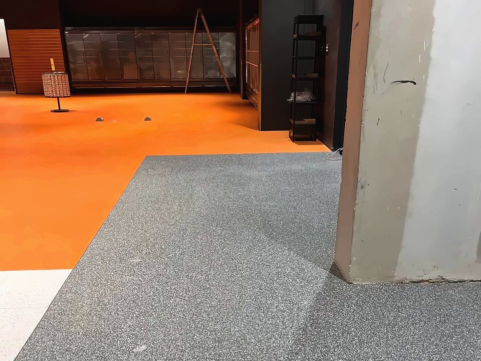 Grey GTI Max interlocking tiles laid at Checkers, with an orange border
