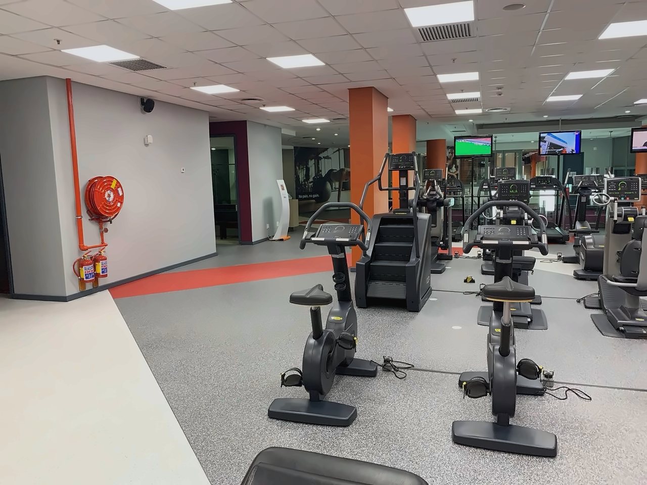 A gym floor in grey and white with a red band, laid by Miccor Flooring