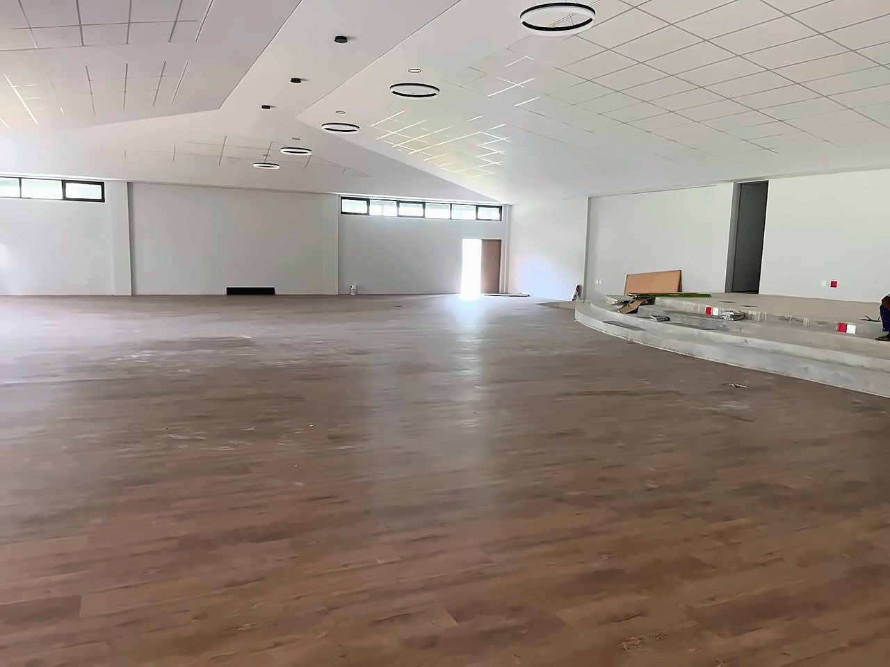 A large hall with a wood-look plank floor