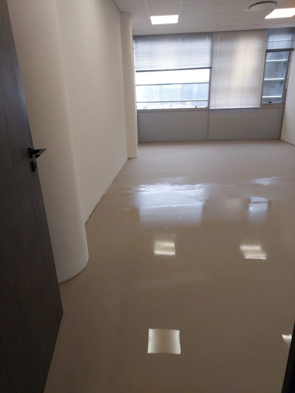 An office with a glossy self-levelled floor